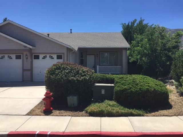 After: the same front yard with shrubs trimmed into neat shapes and the weeds cleared