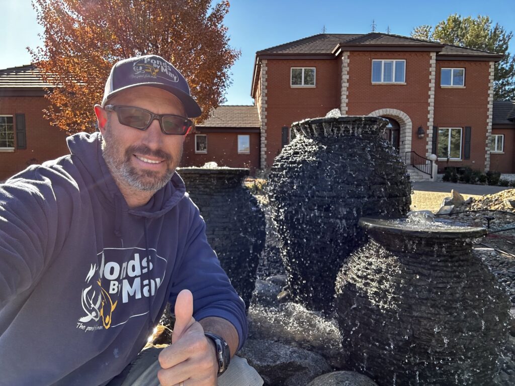 Justin of Ponds By May giving a thumbs-up beside three finished urn fountains