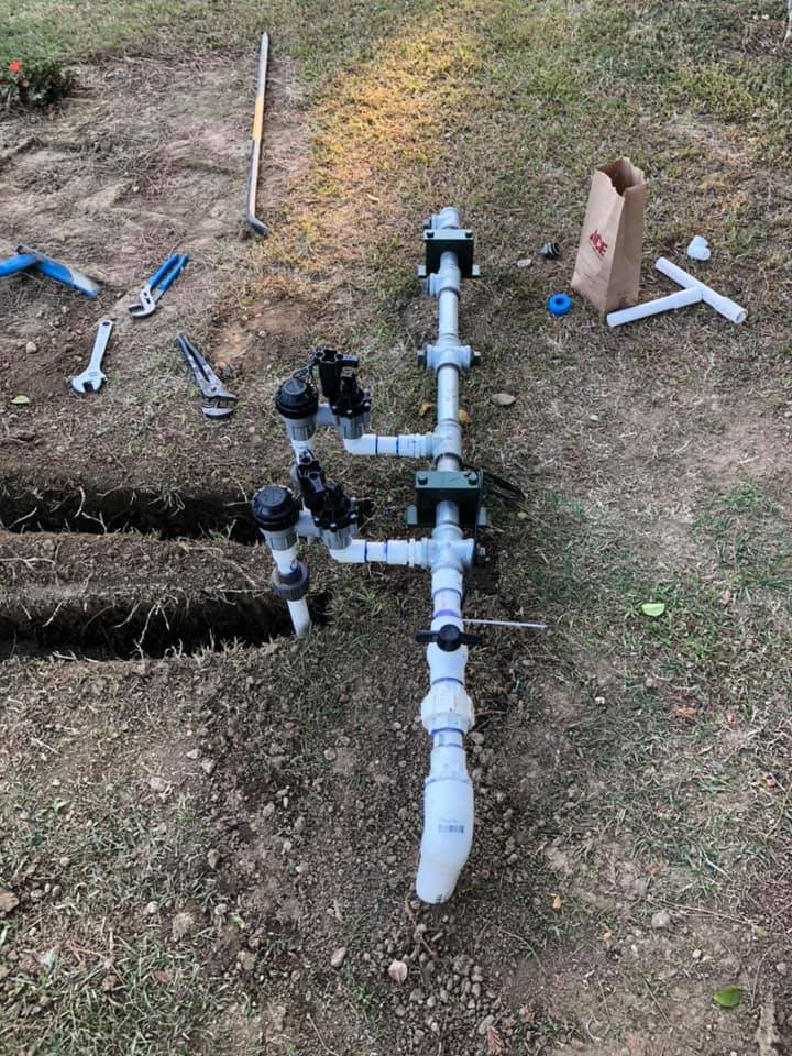 A new irrigation valve manifold with PVC pipe in a trench